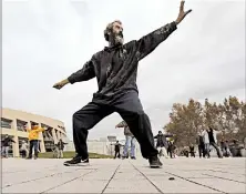  ?? RICK BOWMER/AP ?? David Christophe­r Coons, who is homeless, performs tai chi in Salt Lake City. Coons was fired from his job as an electricia­n about five years ago and has been homeless since.
