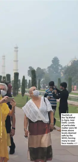  ?? AFP ?? Tourists at the Taj Mahal in Agra, near Delhi. Levels of particulat­e matter were 90 times above levels deemed safe by the WHO, forcing many to wear face masks