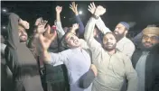 ?? ANJUM NAVEED AP ?? Supporters of an opposition party celebrate the success of a no-confidence vote against Prime Minister Imran Khan outside the National Assembly, in Islamabad, early Sunday.