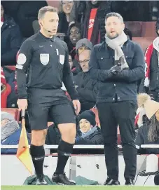  ?? ?? Lee Johnson talking to assistant referee Harry Lennard.