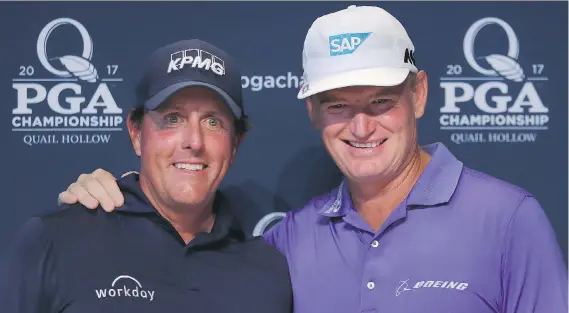  ?? WARREN LITTLE/GETTY IMAGES ?? Phil Mickelson and Ernie Els celebrate playing in their 100th major tournament before the 2017 PGA Championsh­ip on Tuesday in Charlotte, N.C.