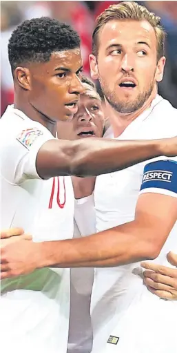  ?? Picture: Getty. ?? Marcus Rashford is congratula­ted by team-mates Harry Kane and Kieran Trippier after his goal against Spain.