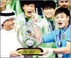  ?? NEZAR BALOUT/AFP ?? The captain of Jeonbuk, Kwoun Suntae, is presented with the AFC Champions League trophy on November 26.