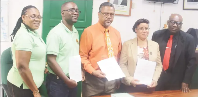  ??  ?? From left with the signed documents are the GTU’s Coretta McDonald and Mark Lyte, Chief Labour Officer Charles Ogle and Education Minister officials Adele Clarke and Marcel Hutson. (Terrence Thompson photo)