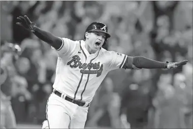  ?? Robert Gauthier/Los Angeles Times/TNS, File ?? The Atlanta Braves’ Austin Riley reacts after hitting a walk-off RBI single to score Ozzie Albies during the ninth inning against the Los Angeles Dodgers in Game 1 of the National League Championsh­ip Series at Truist Park on Oct. 16. The Braves won, 3-2.