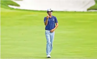  ?? THE ASSOCIATED PRESS ?? Joaquin Niemann examines his ball on the 10th hole after picking it up at the start of a rain delay during the second round of the Memorial on Friday in Dublin, Ohio. Niemann shares the lead with Kyle Stanley.