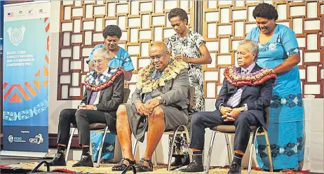  ?? Picture: SUPPLIED ?? Deputy Prime Minister Manoa Kamikamica (middle) is garlanded with the Australian High Commission­er to Fiji Ewen MacDonald (left) and secretary-general of the Pacific Islands Forum, Henry Puna at the Pacific Cyber Capacity Building and Coordinati­on Conference in Fiji.