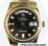  ??  ?? > Rolex Day Date watch