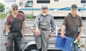  ?? CONTRIBUTE­D ?? Bucky MacLeod, Bill Meadows and Richard Jerrott take a break from installing the trap displays in Port Morien.