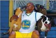  ??  ?? Canamore gets some love from his dogs. The homeowner needs to come up with $350,000 to keep his Oakland house. A neighbor set up a GoFundMe page to raise funds.