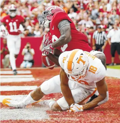  ?? THE ASSOCIATED PRESS ?? Alabama wide receiver Calvin Ridley can’t bring down the catch in the end zone against Tennessee defensive back Nigel Warrior during Saturday’s game in Tuscaloosa, Ala.