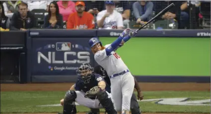  ?? AP PHOTO/CHARLIE RIEDEL ?? Los Angeles Dodgers’ Justin Turner (10) hits a two-run home run during the eighth inning of Game 2 of the National League Championsh­ip Series baseball game against the Milwaukee Brewers on Saturday, in Milwaukee.