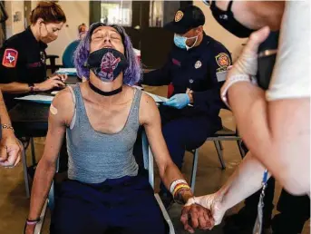  ?? Jessica Phelps / Staff photograph­er ?? Miranda Garcia reacts after getting her vaccine last week at Christian Assistance Ministry. CAM partnered with the San Antonio Fire Department and Metro Health to provide the vaccines.