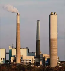  ?? Joshua A. Bickel/associated Press ?? AES Indiana Petersburg Generating Station, a coal-fired power plant, operates on Oct. 25 in Petersburg, Ind. The SEC’S new emissions rule has prompted a rush for companies to sue.