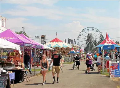  ?? LAUREN HALLIGAN -MEDIANEWS GROUP FILE ?? Event-goers walk through the fairground­s on opening day of the 199th annual Schaghtico­ke Fair last year,