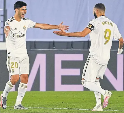  ??  ?? KEY MEN: Real Madrid’s Marco Asensio, left, celebrates his goal with teammate Karim Benzema.