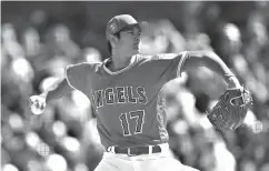  ?? Associated Press ?? ■ In this Feb. 24 file photo, Los Angeles Angels' Shohei Ohtani works against the Milwaukee Brewers during the first inning of a spring training baseball game in Tempe, Ariz. Ohtani is expected to start the season in the Angels’ specially designed...