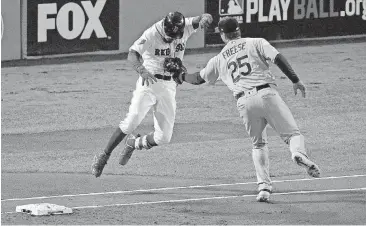  ?? [AP PHOTO] ?? Los Angeles Dodgers first baseman David Freese (25) tags out Boston Red Sox’s Mookie Betts on a grounder to shortstop during the first inning in Game 2 of the World Series on Wednesday night in Boston.