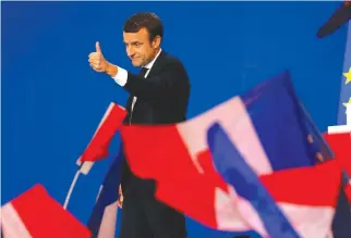  ?? REUTERS ?? EMMANUEL MACRON, head of the political movement En Marche!, or Onwards!, and candidate for the 2017 French presidenti­al election, gestures to supporters after the first round of 2017 French presidenti­al election in Paris, France, April 23.