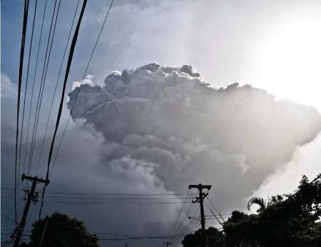  ?? ORVIL SAMUEL AP ?? Ash rises as La Soufriere on the eastern Caribbean island of St. Vincent. ‘This is not simply going to be like a hurricane where it might be a seven day business,’ Prime Minister Ralph Gonsalves said. ‘Depending on the extent of the explosion and the damage done, it could be four months.’
