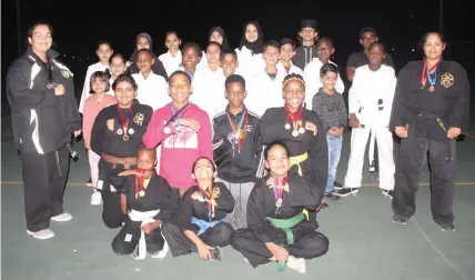  ?? ?? TSKKIA Tokon Samurai karatekas show off their medals.