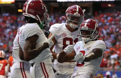  ?? GeTTY images ?? ROLL TIDE: Alabama’s John Metchie III, right, reacts after scoring a touchdown during the first half against Miami on Saturday in Atlanta, Ga.