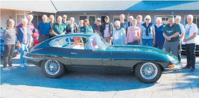  ?? ?? Members of the Wellington Jaguar Drivers Club cluster around Murray Mason in his 1962 E-Type Jaguar at Destinatio­ns Motor Lodge on Saturday, May 7.