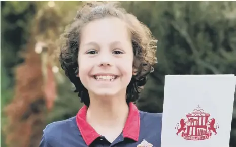  ??  ?? Sunderland fan George Henderson, nine, with his letter from Kyril Louis-Dreyfus.