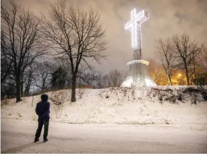  ?? JOHN MAHONEY ?? When it was first erected in 1924, the Gazette described the cross atop Mount Royal as “a memorial to the survival of the Canadian people, whose growth was, in the early struggles, parallel to the growth of the faith which is represente­d by the cross.”