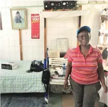  ??  ?? Jennifer Louw, a part-time cleaner and occupier of the Woodstock hopsital, smiles in her room that she shares with her two children.