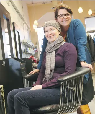  ??  JEAN LEVAC/OTTAWA CITIZEN ?? Connie Amey-Dawson, sitting alongside Samantha Brooks of Hair by Design, says the women of the salon have helped her deal with her cancer diagnosis by sharing their experience­s.