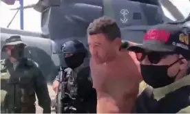  ??  ?? Venezuelan soldiers in balaclavas move a suspect from a helicopter after what Venezuelan authoritie­s described was a mercenary incursion. Photograph: Reuters Tv/Reuters