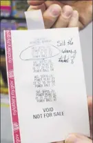  ??  ?? minogue’s Beverage employee Jeff decker holds a printout of winning Powerball numbers on thurs. in malta. numbers from Wed.’s drawing are circled. the jackpot is $94 million.