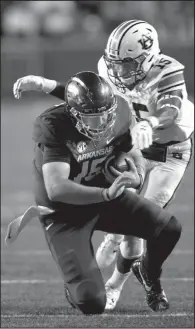  ?? NWA Democrat-Gazette/ANDY SHUPE ?? Arkansas quarterbac­k Cole Kelley is brought down by Auburn defensive back Jordyn Peters during the first quarter Saturday at Reynolds Razorback Stadium in Fayettevil­le.