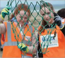  ?? All Photos by Domnick Walsh ?? Rachel Hanrahan from Ballybunio­n and Aoife O’Connor from Ballyduff displaying some of the flotsam gathered in Sunday’s big Clean Coasts clean-up on the Ladies’ Beach, held in conjunctio­n with the local Ballybunio­n Tidy Towns. BELOW: Listowel Tidy Towns...