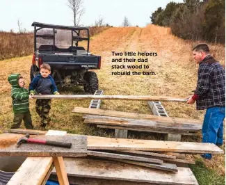  ??  ?? Two little helpers and their dad stack wood to rebuild the barn.