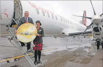  ??  ?? Jonathan Hinkles, managing director of Loganair and Sharon Williams, Loganair cabin crew, celebrate the airline’s award.