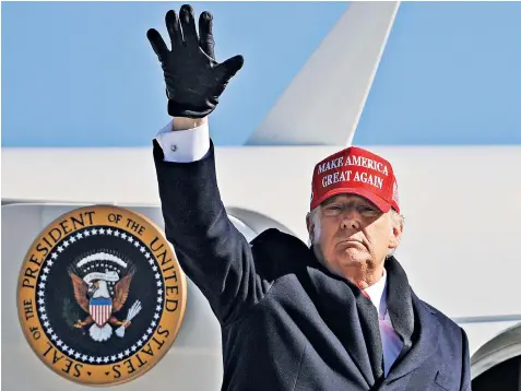  ??  ?? Donald Trump boards Air Force One following a campaign rally at Fayettevil­le Regional Airport, North Carolina, on a last-minute stop the day before the polls close