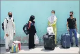  ?? VIPIN KUMAR/HT ?? Migrant workers queue up at Ambedkar Stadium to undergo n thermal screening before registerin­g for special trains.