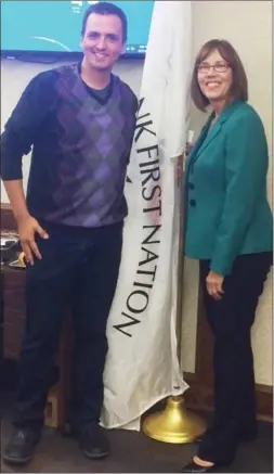  ?? Special to Westside Weekly ?? The Westbank First Nation’s flag has been added to the Regional District of Central Okanagan’s boardroom. Above are, left, Tom Konert, a non-voting WFN appointee to the regional board, and board chair Gail Given, who is also a City of Kelowna councillor.