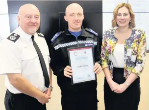  ??  ?? Deputy Chief Constable Richard Lewis, left, and Assistant Police and Crime Commission­er for South Wales Bonnie Navarra present Bridgend PCSO Richard Thomas with an award