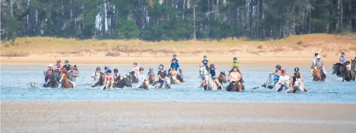  ?? Photo / Karen Newton ?? Fifty-five riders brave the cold on the final leg of the trek across the Whananaki estuary.