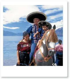  ??  ?? A local family saddle up on the coast of Lake Atitlan, Guatemala.