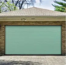  ??  ?? Right: Made from aluminium with a steel lath along the bottom for added strength, Gliderol’s electric roller garage door in Chartwell Green also has an insulated core. Bespoke made in sizes 2,147mm to 2,451mm wide, from £1,244, Direct Doors
