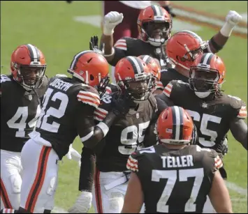  ??  ?? Cleveland Browns’ Myles Garrett is congratula­ted by teammates after a fourth quarter strip sack of Washington Football Team’s Dwayne Haskins Jr. on Sunday, September 27, 2020 at Firstenerg­y Stadium in Cleveland, Ohio. The Browns won the game 34- 20. ( Phil Masturzo/ Akron Beacon Journal/ TNS)