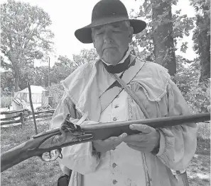  ??  ?? Glenn Bittner demonstrat­es loading and firing a musket. A well-drilled soldier or militiaman could fire three times per minute. JOHN BORDSEN FOR USA TODAY