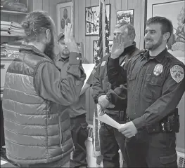  ??  ?? HE SOLEMNLY PROMISES—Austin Martino, newly hired Nome police officer takes his oath of office administer­ed by Bryant Hammond, city clerk. Martino comes from New York.