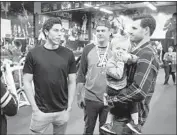  ??  ?? YELICH, left, a Westlake High graduate, chats with Shane Kroker and Ryan Sorensen, holding son Cole.