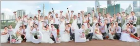  ?? CHEN XIAOGEN / FOR CHINA DAILY ?? A total of 20 couples in wedding gowns and suits had their special moment at Xiangmi Park.