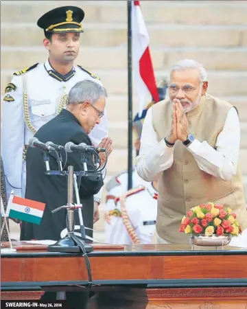  ?? AJAY AGGARWAL/HT ARCHIVE ?? Prime Minister Narendra Modi greets then President Pranab Mukherjee at the swearingin ceremony in New Delhi.